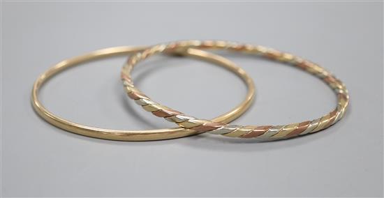 A 9ct three-colour gold bangle and another 9ct yellow gold bangle.